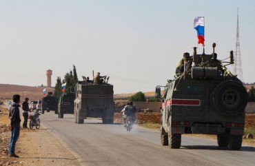 A convoy of Russian military vehicles drives toward the northeastern Syrian city of Kobane on October 23, 2019.