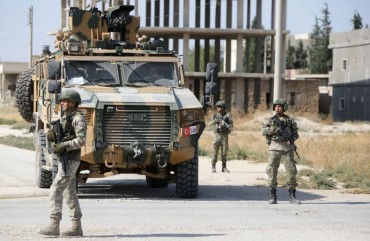 Turkish soldiers patrol the northern Syrian Kurdish town of Tal Abyad, on the border between Syria and Turkey, on October 23, 2019