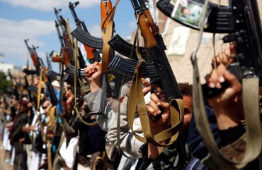 Houthi followers hold their guns during a tribal gathering against the continued war and blockade on October 03, 2019 in Sana'a, Yemen.