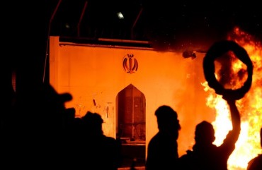 Iraqi demonstrators gather as flames start consuming Iran's consulate in the southern Iraqi Shiite holy city of Najaf on November 27, 2019, two months into the country's most serious social crisis in decades.