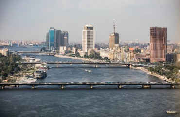 A complete overview of the Ramses Hilton Hotel (R), the Maspero Television Building (C) and the building of the Egyptian Ministry of Foreign Affairs with a view of the Qasr El Nil Bridge (front) on the banks of the Nile. 