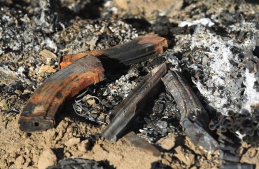 Damaged military gear is scattered on the ground at the site of an Islamic State (IS) group attack, a day earlier, on a unit of Iraq's Hashed al-Shaabi (Popular Mobilisation Forces) in Mukaishefah, about 180km (110 miles) north of the capital, on May 3, 2020.