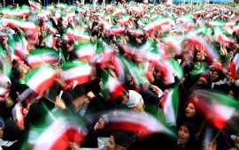 Iranian schoolgirls wave their national flag during celebrations in Tehran's Azadi Square (Freedom Square) to mark the 37th anniversary of the Islamic revolution on February 11, 2016.