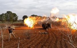 An opposition fighter fires a gun from a village near al-Tamanah during ongoing battles with government forces in Syria's Idlib province on January 11, 2018