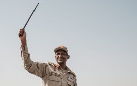Mohamed Hamdan Dagalo, known as Himediti, deputy head of Sudan's ruling Transitional Military Council (TMC) and commander of the Rapid Support Forces (RSF) paramilitaries, waves a baton to supporters on a vehicle as he arrives for a rally in the village of Abraq, about 60 kilometers northwest of Khartoum, on June 22, 2019. (YASUYOSHI CHIBA/AFP/Getty Images)
