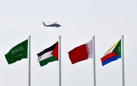a helicopter flying over flags at the Ithra center during the 29th Summit of the Arab League in Dhahran in Eastern Province, Saudi Arabia on April 15, 2018.