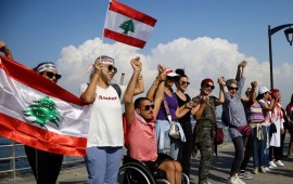 Lebanese people hold hands as they form a human chain, that stretched out along the coast from the capital Beirut to northern and southern Lebanon, symbolizing national unity, on the 11th day of anti-government protests across Lebanon. 