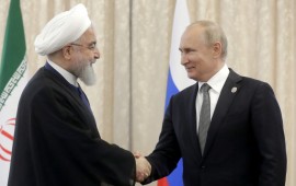 Iran's President Hassan Rouhani (L) and Russia's President Vladimir Putin shake hands as they meet on the sidelines of a meeting of the Shanghai Cooperation Organisation (SCO) Council of Heads of State.