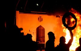 Iraqi demonstrators gather as flames start consuming Iran's consulate in the southern Iraqi Shiite holy city of Najaf on November 27, 2019, two months into the country's most serious social crisis in decades.