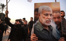 Supporters of the predominantly Shia Muslim Popular Mobilization Forces (PMF) gather with flags and posters of the PMF deputy head Abu Mahdi al-Muhandis during an anti-US protest after the US airstrike in Baghdad