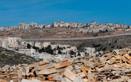 A picture taken on January 27, 2020 shows Israel's controversial concrete barrier (C) separating the Jewish settlement of Neve Yaakov (foreground) in the northern part of east Jerusalem and the Palestinian area of al-Ram (background) in the occupied West Bank. 