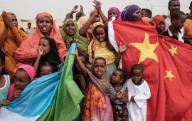 People hold Chinese and Djiboutian national flags as they wait for the arrival of Djibouti's President Ismail Omar Guellehas before the launching ceremony of new 1000-unit housing contruction project in Djibouti, on July 4, 2018. - The new 1000-unit construction project by the Ismail Omar Guelleh Foundation for Housing is financially supported by China Merchant, the operation parther of newly inaugurated Djibouti International Free Trade Zone (DITTZ) with Djibouti Ports and Free Zones Authority, to build ba