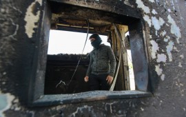  A protester stands inside a burned checkpoint during the sit-in against deadly US airstrikes on sites of a Shiite militia in front of the US embassy. Iraqi mourners on Tuesday stormed the building of the US embassy in Baghdad's heavily fortified Green Zone.