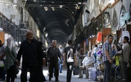 Shoppers walk through the Bzourieh market in the centre of the Syrian capital Damascus on September 11, 2019. 