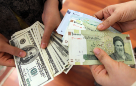 This picture illustrates Iranians on January 12, 2012 counting and exchanging the United States 100-dollar bills and Iran's Rial banknotes, bearing a portrait of Iran's late founder of Islamic Republic Ayatollah Ruhollah Khomeini in Tehran. The Rial's plunge, to 18,000 to the dollar hit a record low on January 18, based on rates in black market trading that the government has tried to ban.