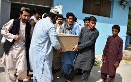 Relatives carry a coffin with the body of television journalist Nemat Rawan after he was shot dead by gunmen, in Kandahar Provicne on May 6, 2021.