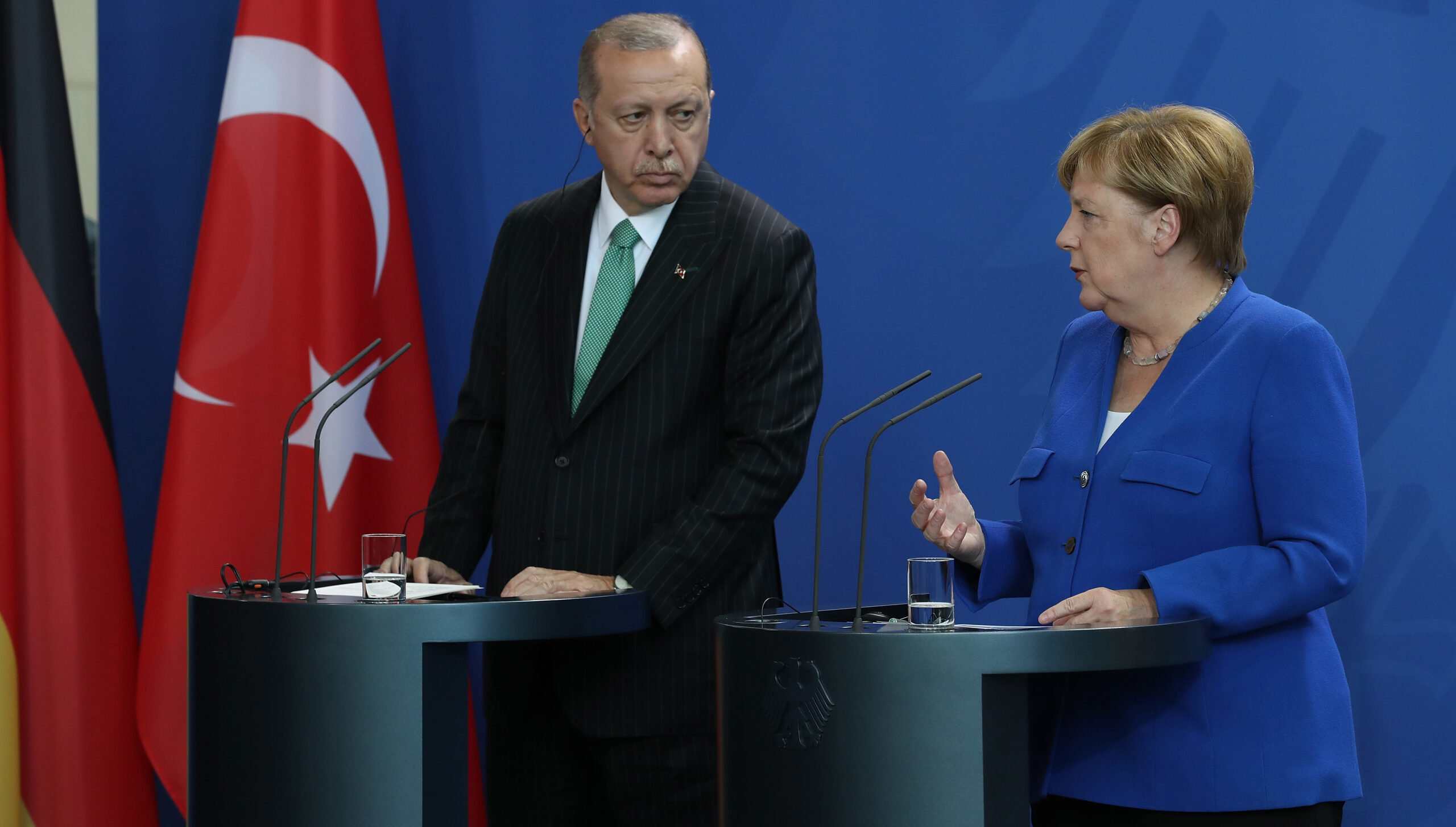 Recep Tayyip Erdogan and Angela Merkel at podium 