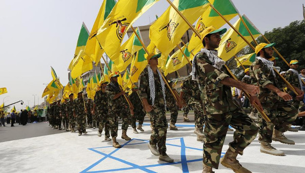 Iraqi Hezbollah soldiers marching with flags