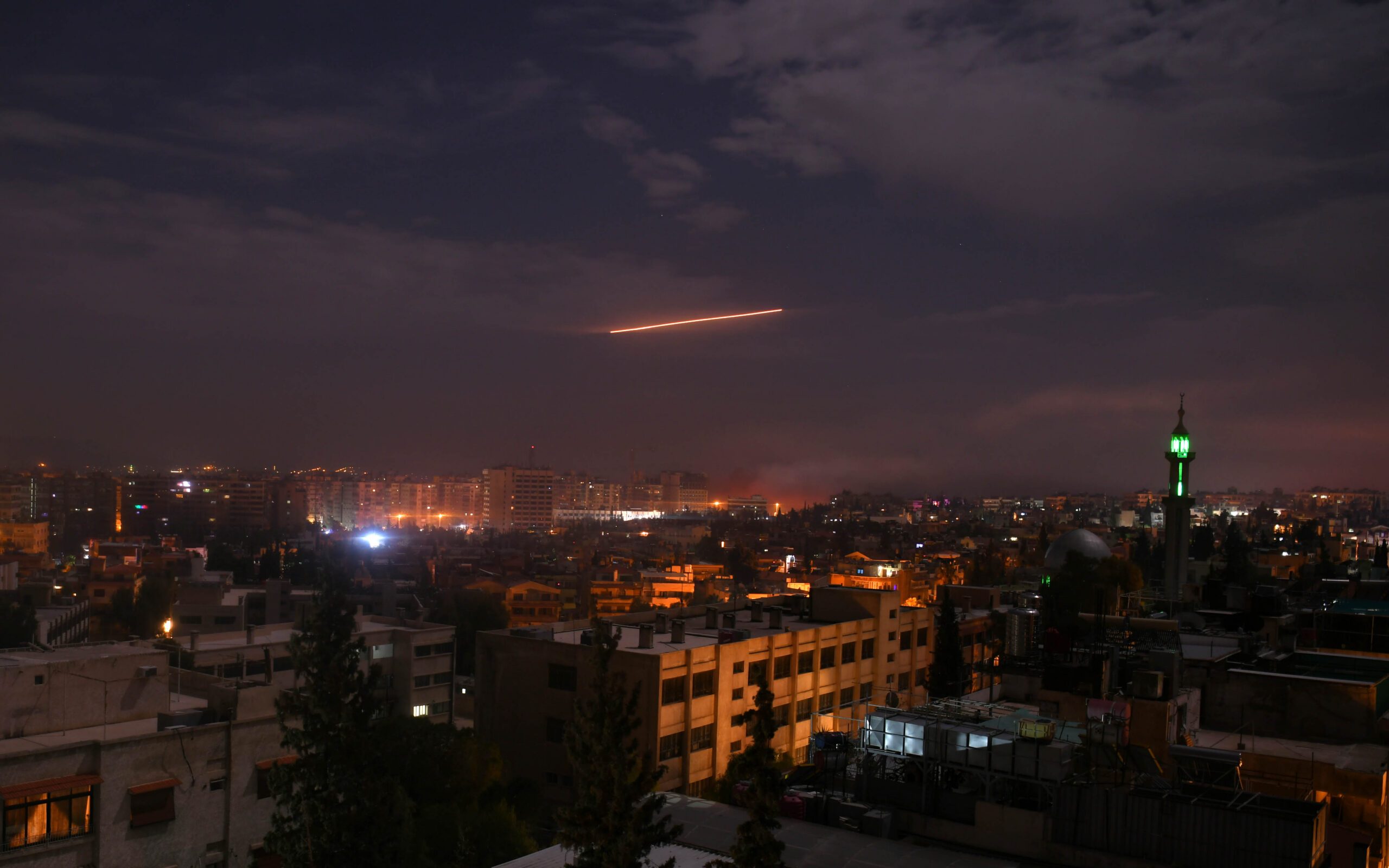 Syrian air defense batteries responding to Israeli missiles targeting Damascus