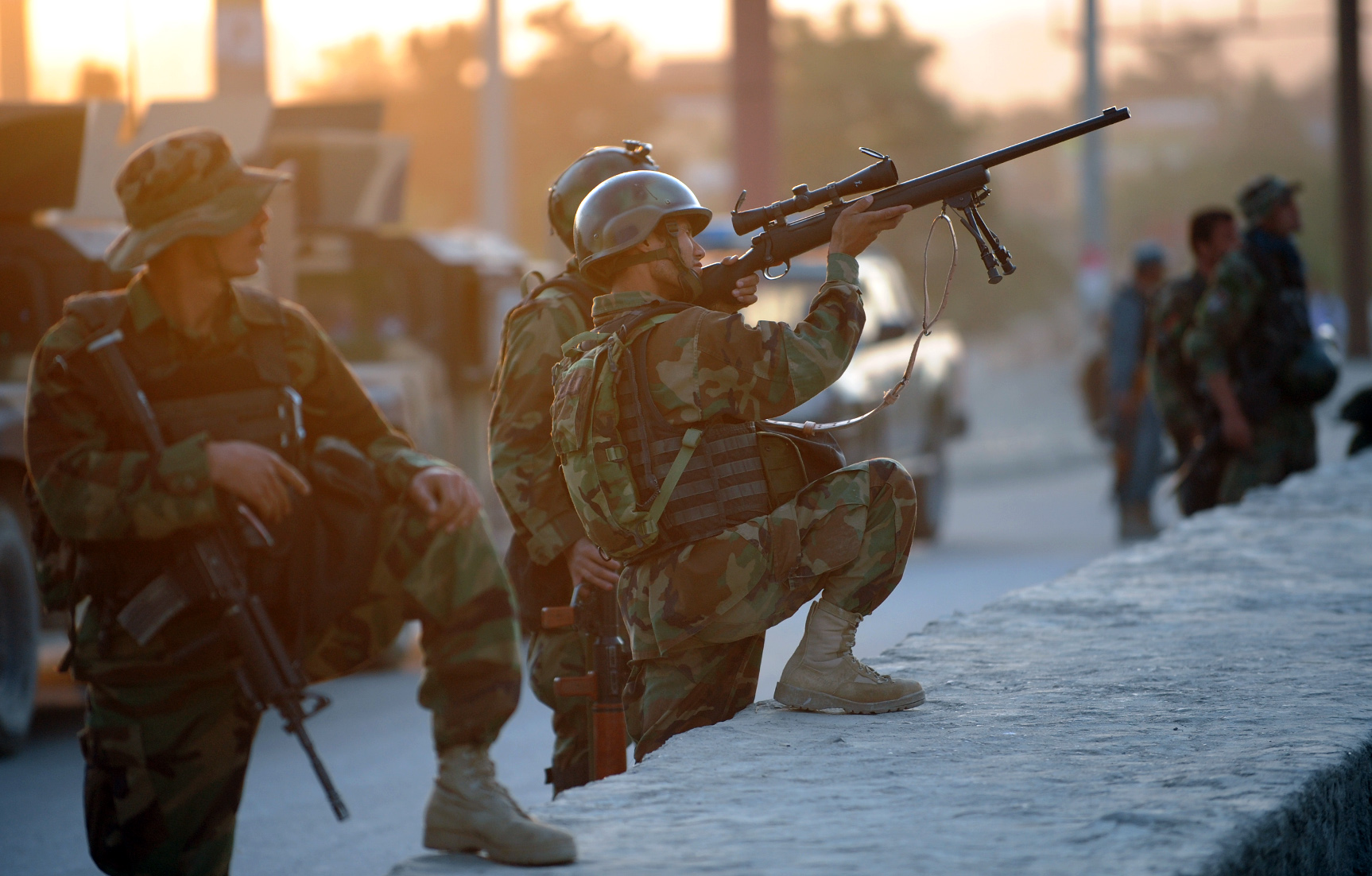 An Afghan soldier aims his gun as he guards the area surrounding the Intercontinental hotel during a military operation against Taliban militants that stormed the hotel in Kabul on June 29, 2011.