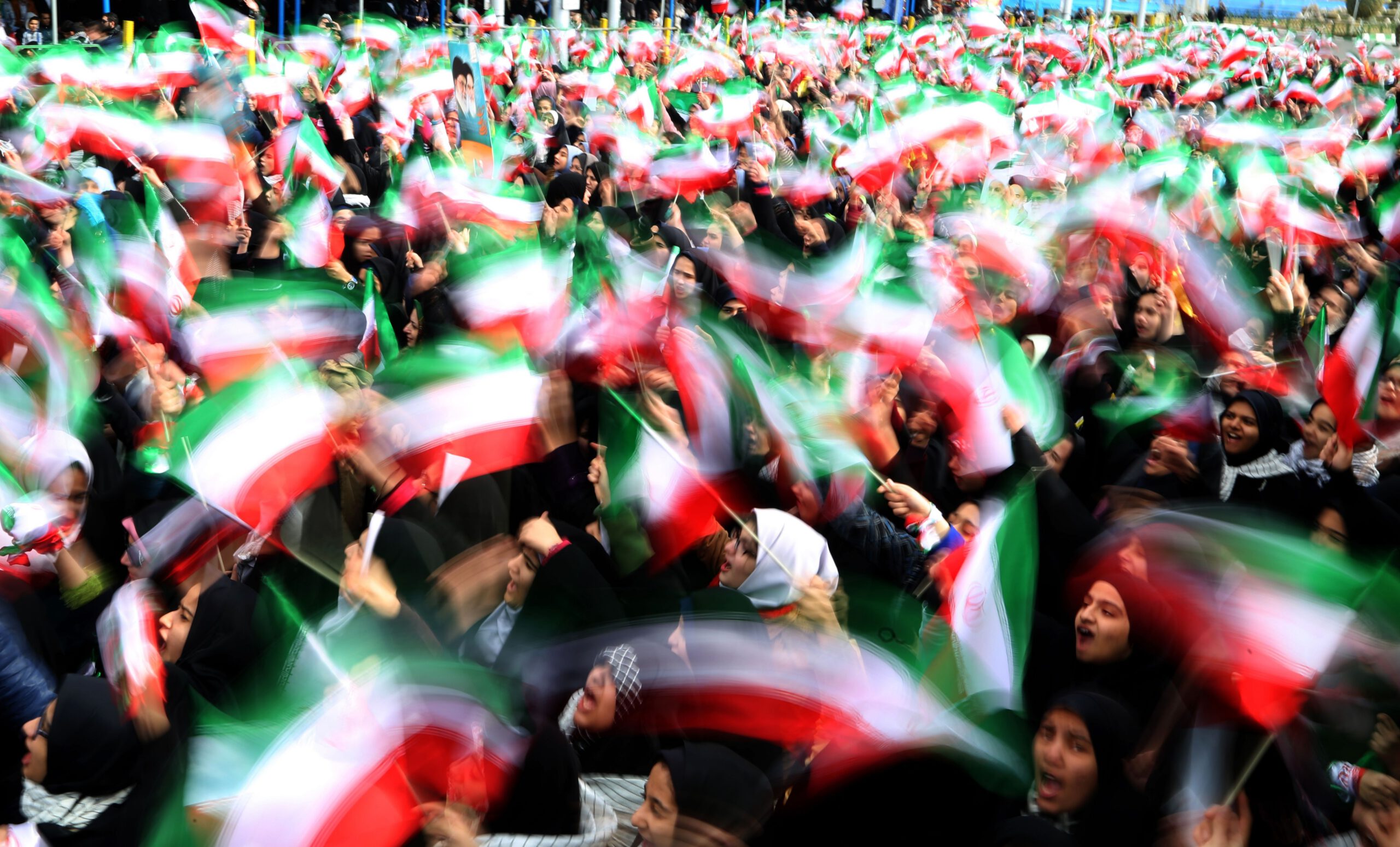 Iranian schoolgirls wave their national flag during celebrations in Tehran's Azadi Square (Freedom Square) to mark the 37th anniversary of the Islamic revolution on February 11, 2016.