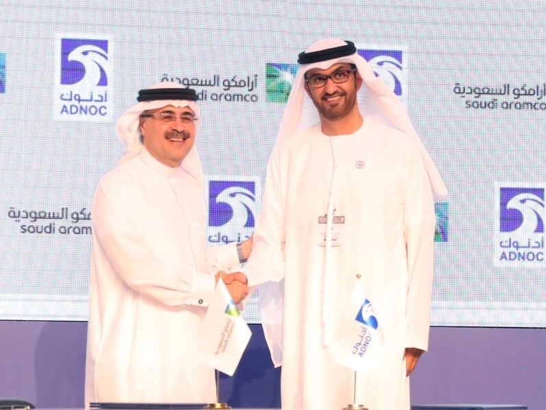 Sultan Ahmed al-Jaber(R), the director general and CEO of ADNOC, shakes hands with Saudi Aramco CEO Amin Nasser after signing a cooperation deal in Abu Dhabi on November 12, 2018.