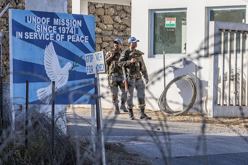 UNDOF forces stand guard at the entrance to the UN headquarters, in the demilitarized zone, near the Quneitra border crossing in the Israeli annexed Golan Heights on September 5, 2014