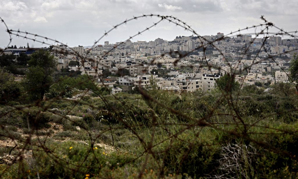 A picture taken from the Israeli settlement of Gilo in Jerusalem, shows the occupied West Bank city of Bethlehem behind barbed wire, on April 17, 2019..