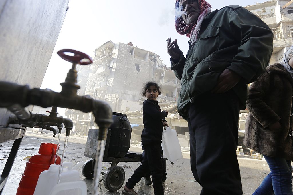 Syrians getting water from a tap 
