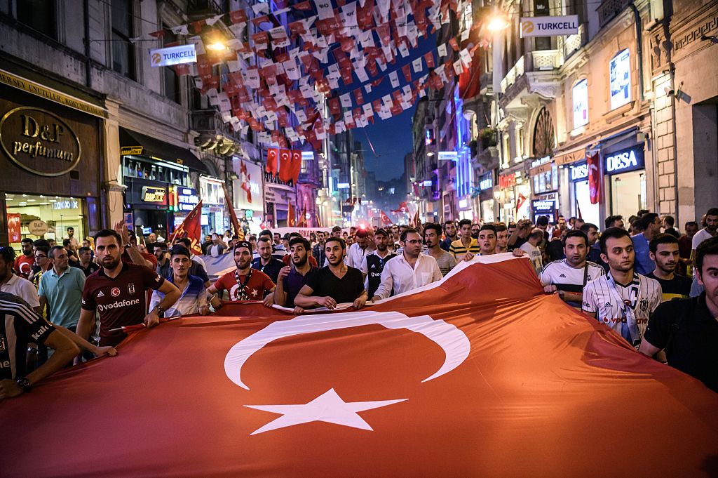 Turks parade through the street with a flag 