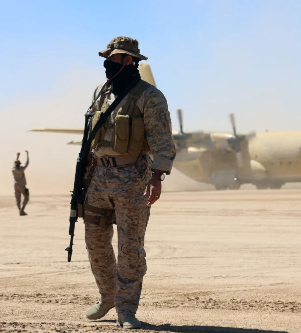 Saudi soldiers stand guard as a Saudi air force cargo plane, carrying aid, lands at an airfield in Yemen's central province of Marib, on February 8, 2018. 