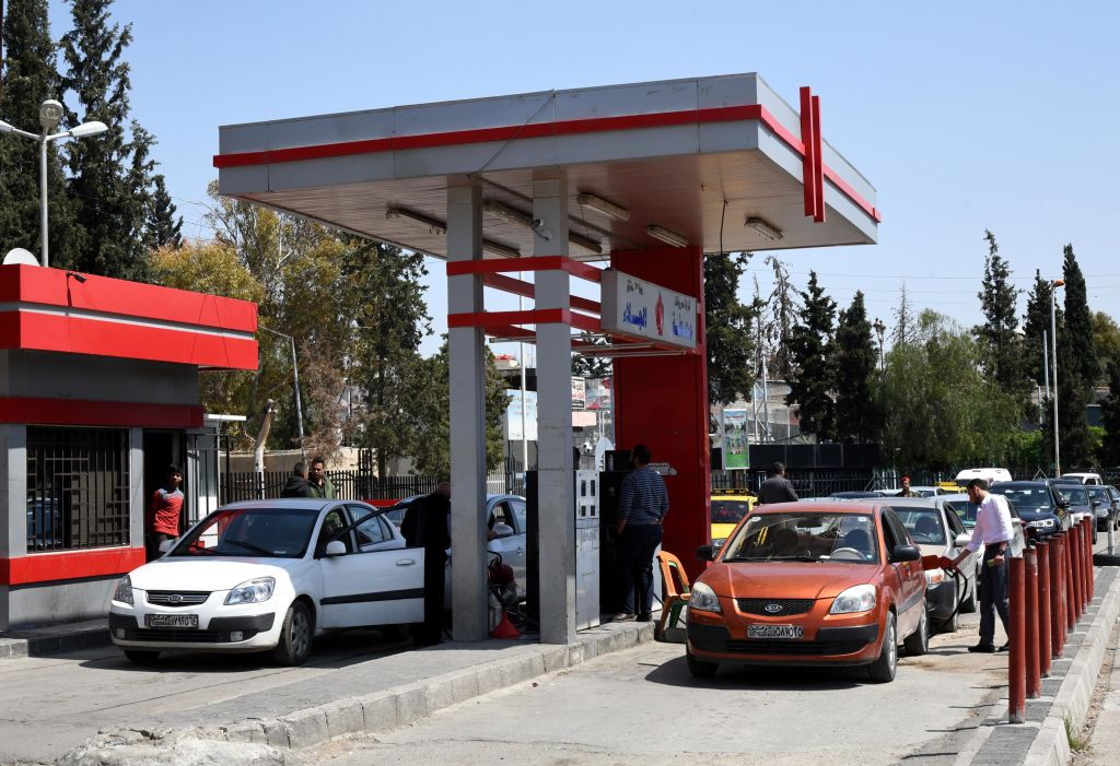 Syrians line up to fill their cars up with petrol at a gas station in Damascus, Syria, on April 23, 2019. 