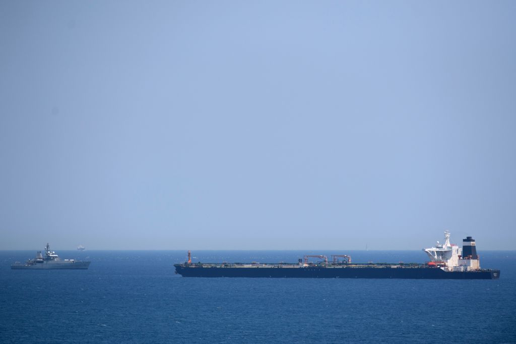 A British Royal Navy ship (L) patrols near supertanker Grace 1 suspected of carrying crude oil to Syria in violation of EU sanctions after it was detained off the coast of Gibraltar on July 4, 2019.