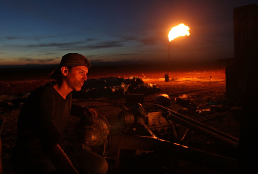 A Syrian worker is pictured on October 31, 2018 at a primitive oil facility in the town of Zardana in the countryside of the northwestern Syrian Idlib Province.