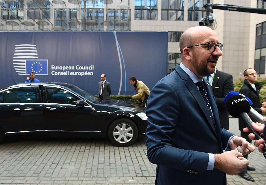 Belgium's Prime minister Charles Michel (R) addresses journalists as he arrives for the second day of an European Union leaders summit to discuss Syria, relations with Russia, trade and migration, on October 21, 2016 at the European Council, in Brussels