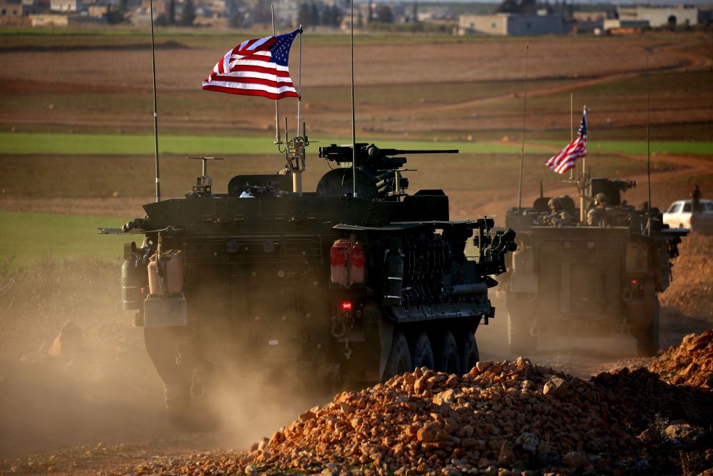 A convoy of US forces armoured vehicles drives near the village of Yalanli, on the western outskirts of the northern Syrian city of Manbij, on March 5, 2017
