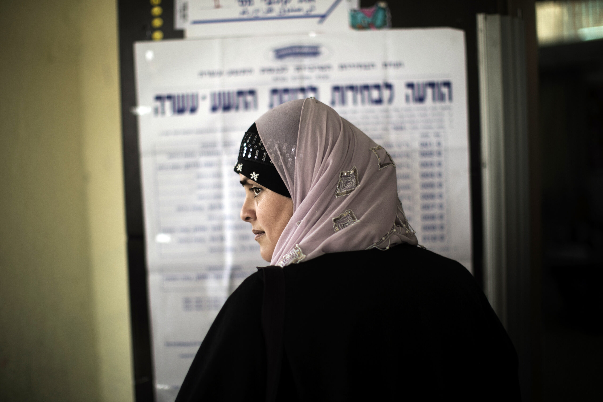 An Arab-Israeli woman waits in line before voting in the northern Israeli village of Maghar January 22, 2013. 