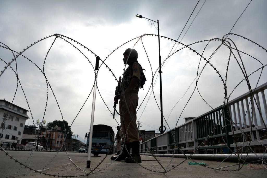 A security personnel stands guard on a street during a lockdown in Srinagar on August 11, 2019, after the Indian government stripped Jammu and Kashmir of its autonomy.