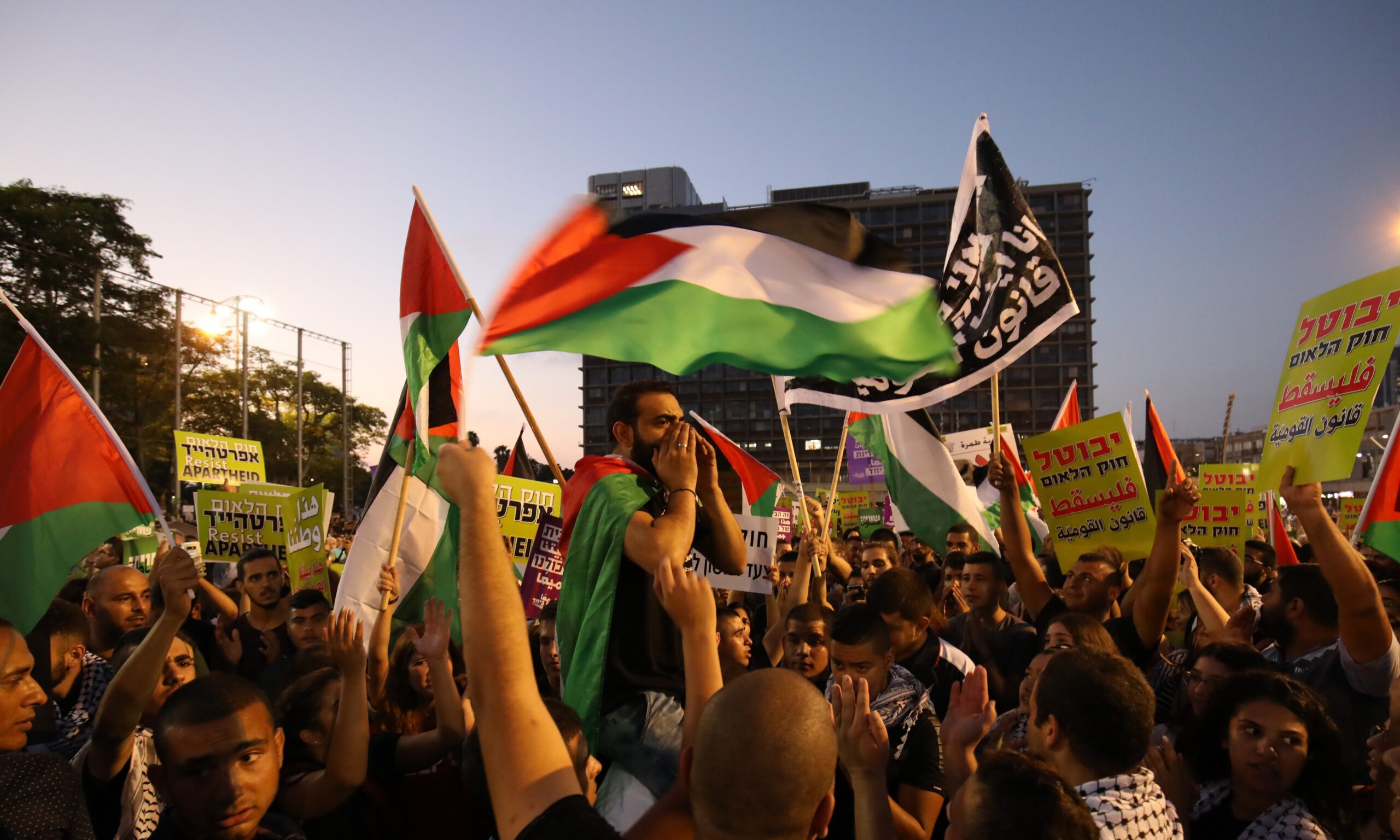 Thousands of Palestinian demonstrators hold banners and flags as they gather at Rabin Square during a protest against the Jewish Nation-State law in Tel Aviv, Israel on August 11, 2018.