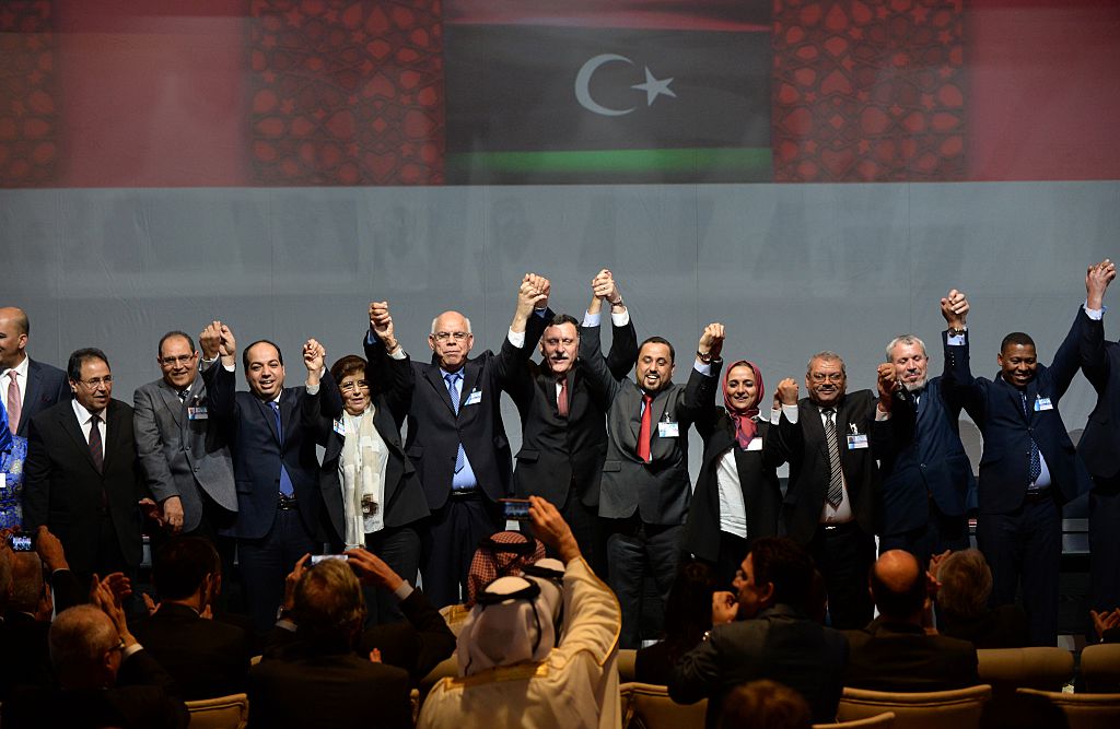 Libya's General National Congress (GNC) deputy president Saleh al-Makhzoum (C-R), the new national government head, Prime Minister, Fayez al-Sarraj (C) and the head of the Tobruk-based House of Representatives Mohammed Ali Shoeb (C-L) celebrate after signing a deal on a unity government on December 17, 2015, in the Moroccan city of Skhirat. 