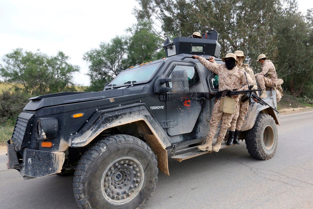 Members of the Tripoli Protection Force, an alliance of militias from the capital city, patrol an area south of the Libyan capital on January 18, 2019, during clashes with the Seventh Brigade group from the town of Tarhuna.