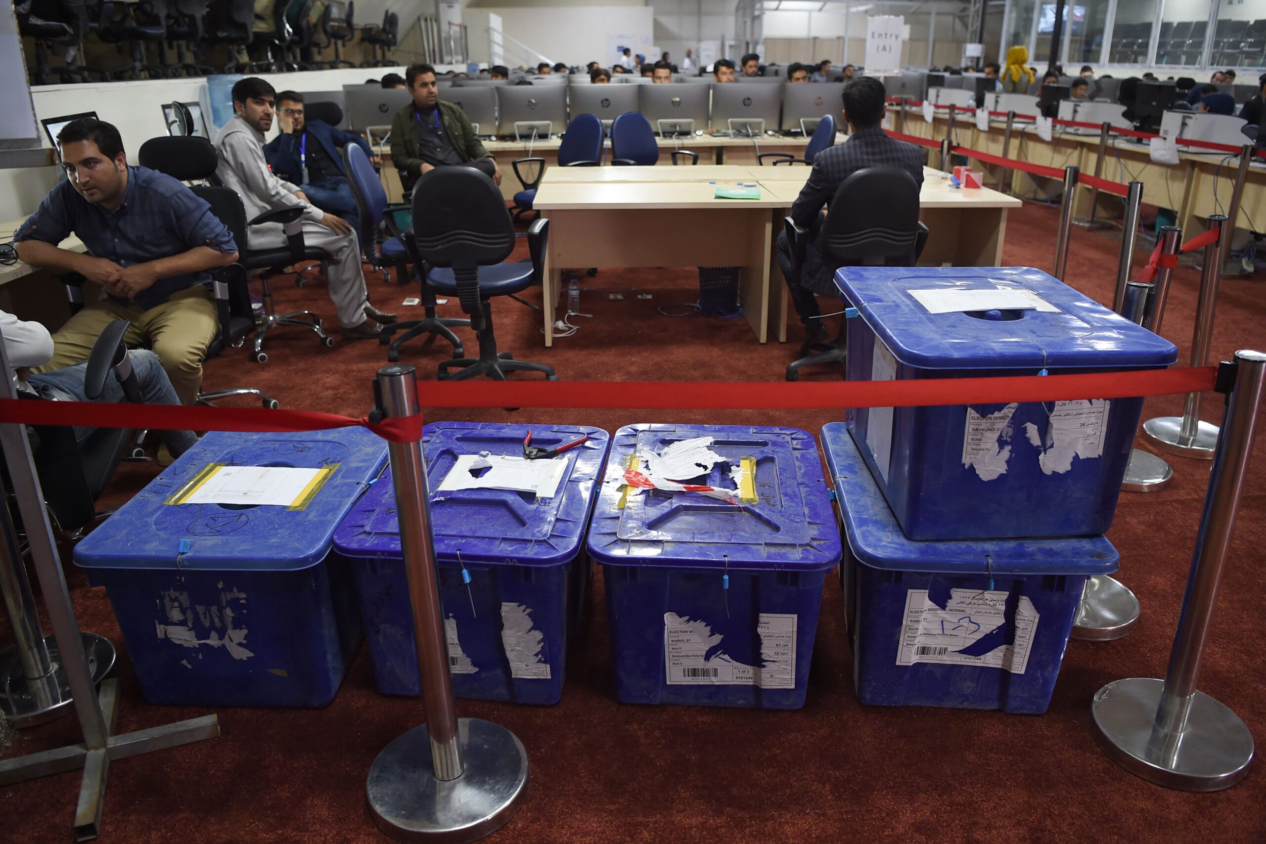 Independent Election Commission (IEC) workers sit at a computer terminal while election information from all over the country is gathered at the Data Centre in Kabul on October 2, 2019. - Voter participation in last weekend's Afghan presidential election will be much less than a third, the country's Independent Election Commission said on October 1, marking a record-low turnout. (Photo by WAKIL KOHSAR / AFP) (Photo by WAKIL KOHSAR/AFP via Getty Images)