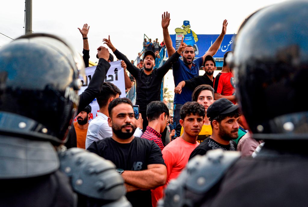 Protesters chant slogans during a demonstration against corruption and lack of basic services in the central Iraqi shrine city of Najaf on October 1, 2019.