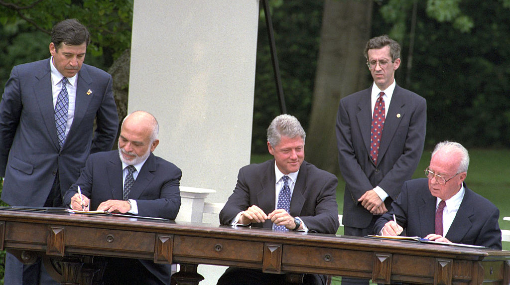 The Israel-Jordan peace treaty being signed in 1994. US President Bill Clinton watches Jordan's King Hussein and Israeli Prime Minister Yitzhak Rabin sign the treaty on the White house lawn