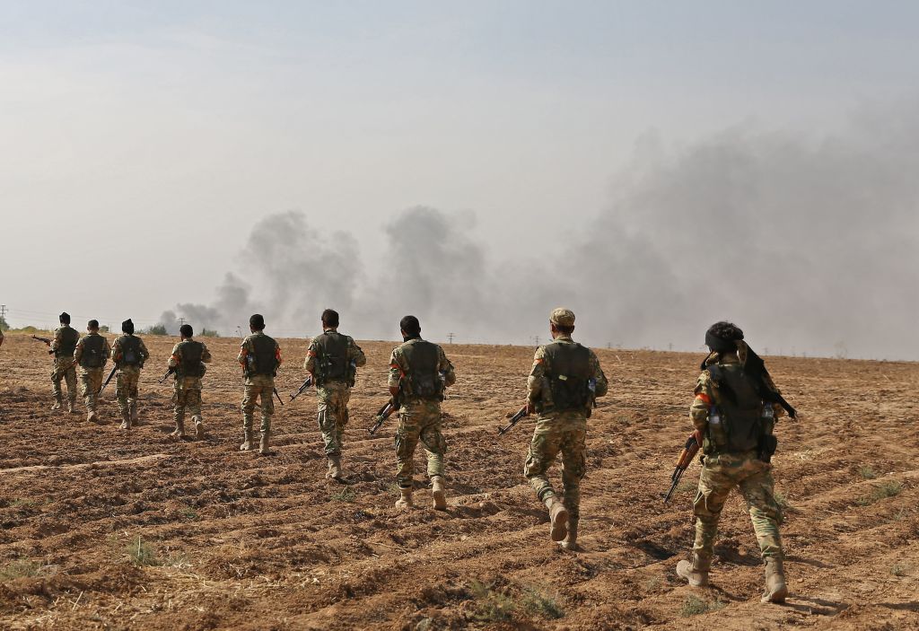  Pro-Turkish Syrian fighters cross the border into Syria as they take part in an offensive against Kurdish-controlled areas in northeastern Syria launched by the Turkish military, on October 11, 2019.