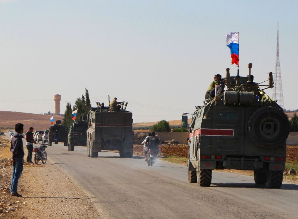 A convoy of Russian military vehicles drives toward the northeastern Syrian city of Kobane on October 23, 2019.