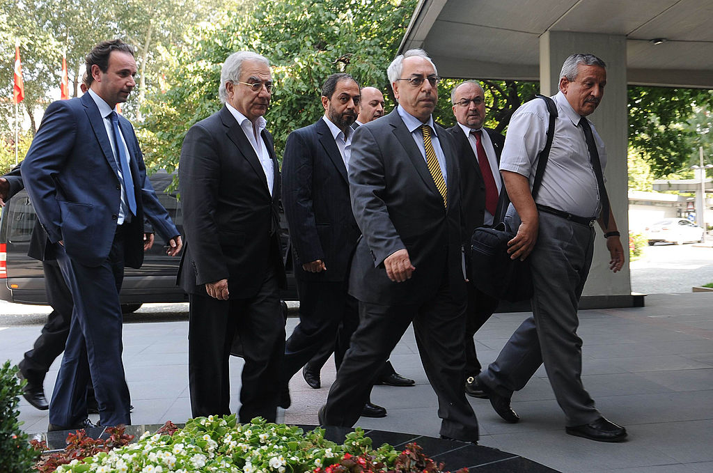 The members of the Syrian National Council and its head Abdulbaset Sieda (2-R) arrive for a meeting with Turkey's Foreign Minister Ahmet Davutoglu in Ankara on July 23, 2012. 