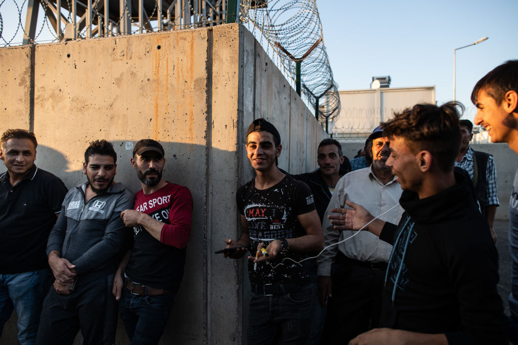 Syrian refugees wait in queue to enter to the Kahramanmaras refugee camp after coming from shopping on September 19, 2019 in Kahramanmaras, Turkey.