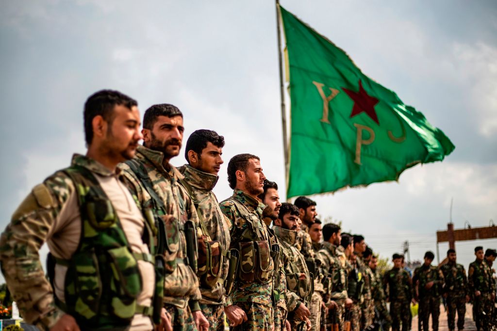 Members of the Kurdish-led Syrian Democratic Forces (SDF) attend the funeral of an Arab fighter in SDF who was killed the previous week in the eastern Deir Ezzor province, in northeastern Syrian Kurdish-majority city of Qamishli on April 10, 2019.
