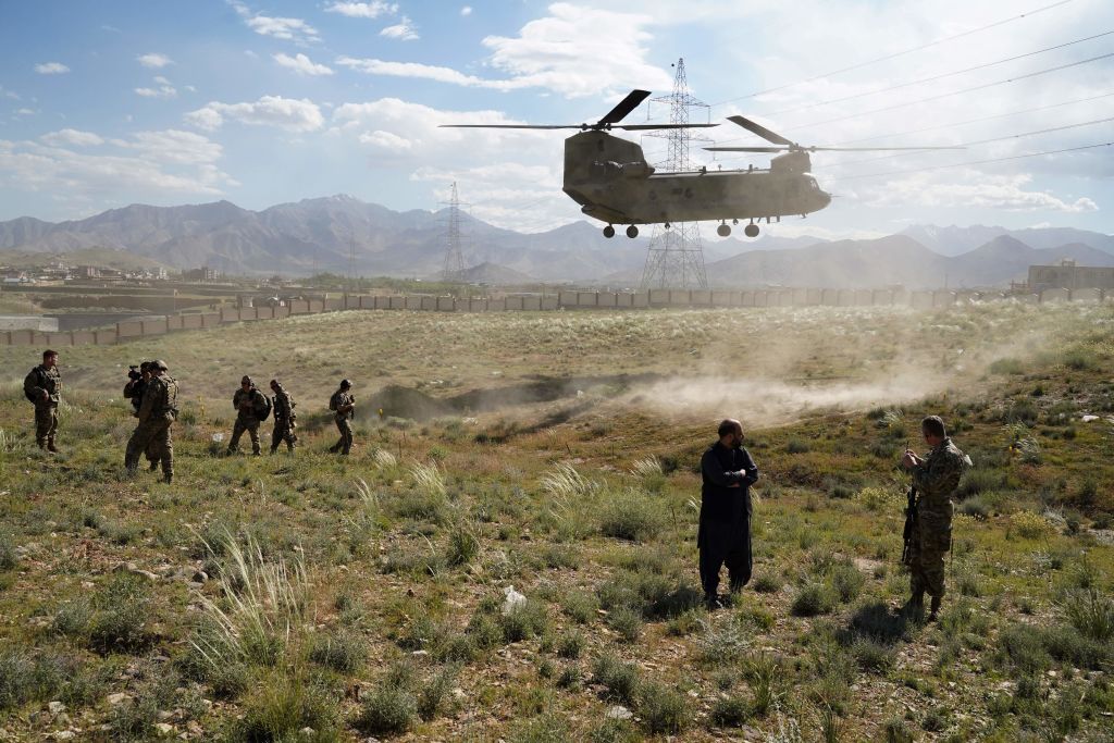 In this photo taken on June 6, 2019, a US military Chinook helicopter lands on a field outside the governor's palace during a visit by the commander of US and NATO forces in Afghanistan, General Scott Miller, and Asadullah Khalid, acting minister of defense of Afghanistan, in Maidan Shar, capital of Wardak province. 